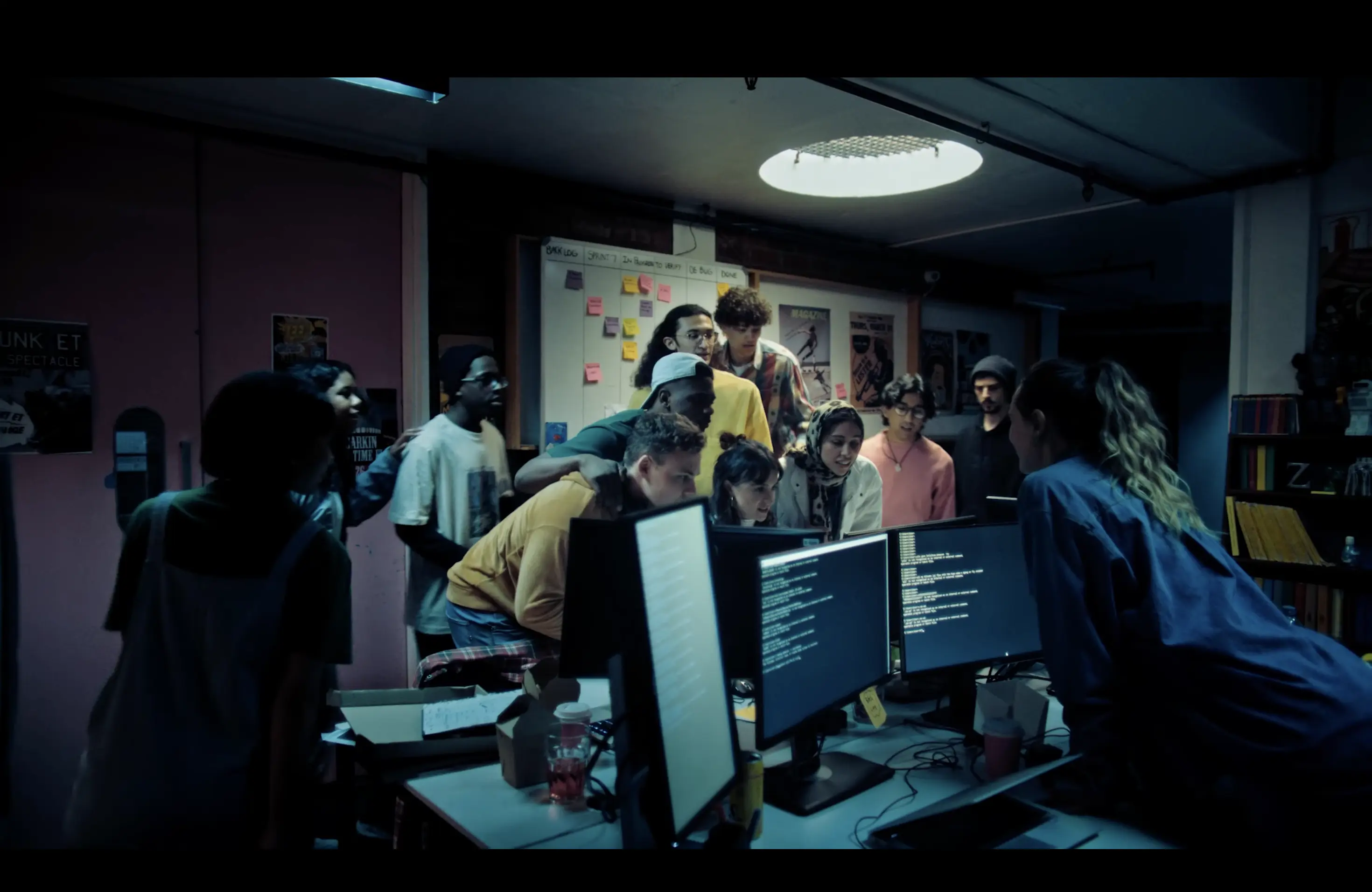 Programmers gathered around computers